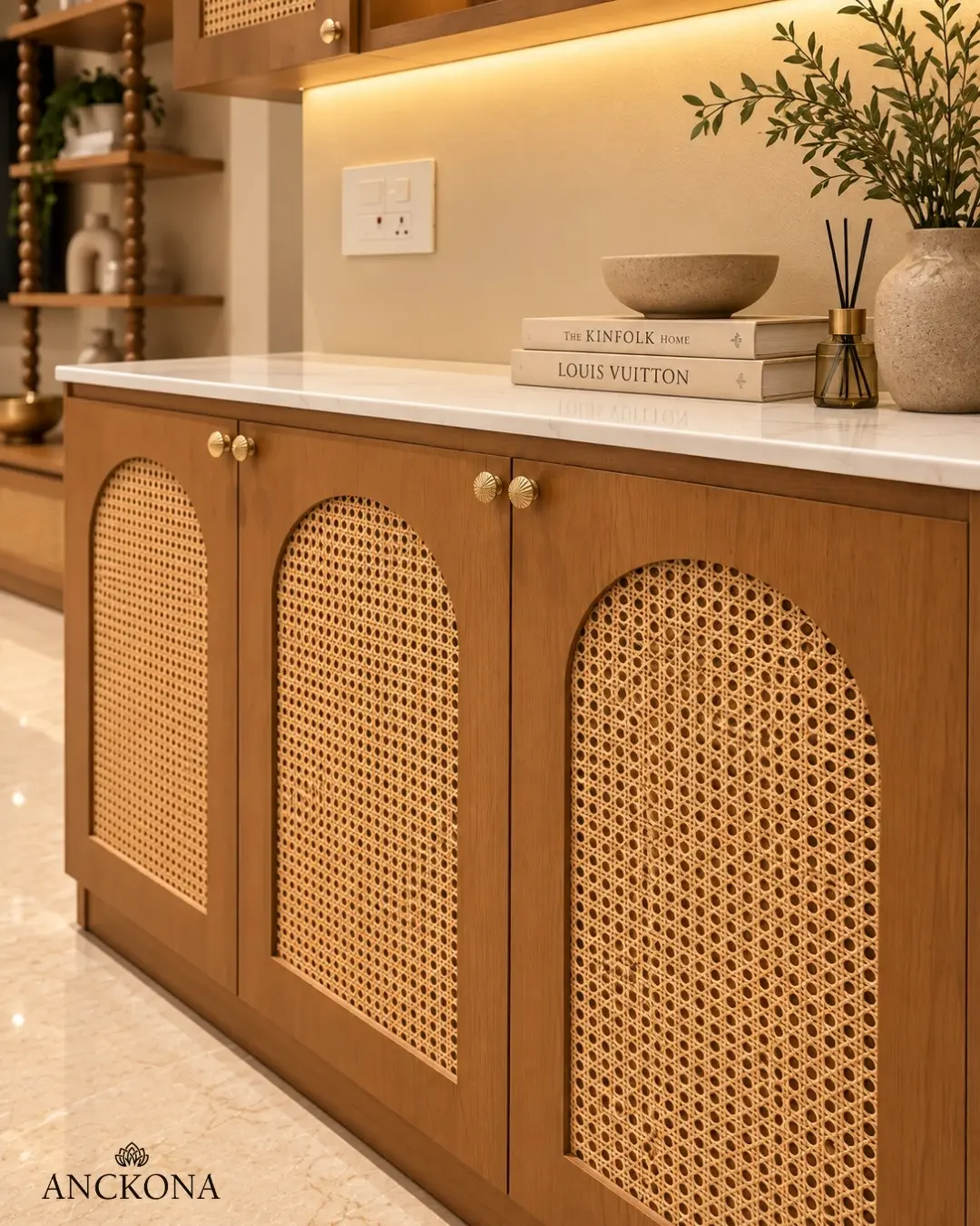 Cane-fronted cabinet with warm wood and brass details